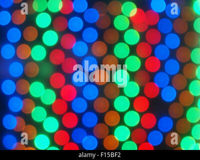 Defocused and blurry image of multicolored lights on a dark background in the form of circles in the correct order was blurred f Stock Photo