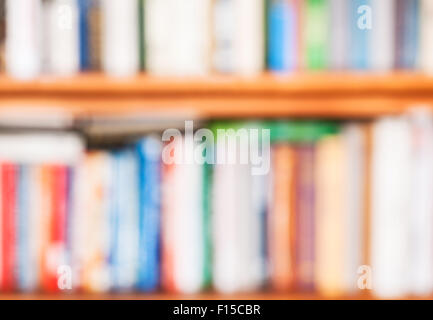 blurred background from many books on bookshelf Stock Photo