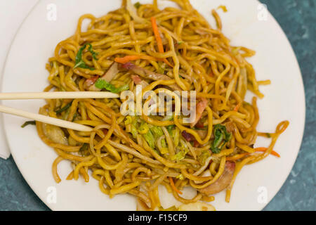 Eating Chinese pork lo mein noodles with chopsticks Stock Photo