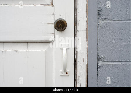 White wooden locked door with lock and metal handle Stock Photo