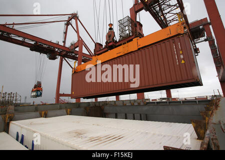 Shipping containers being loaded aboard Stock Photo