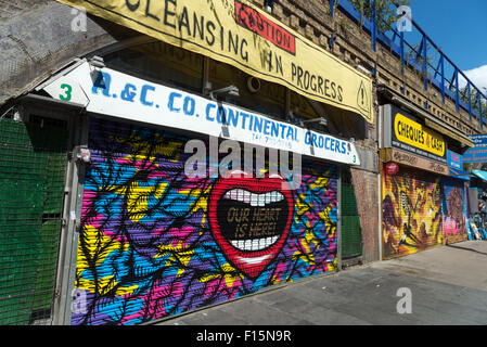 Colourful metal shop shutters at Brixton arches, London, England, UK Stock Photo