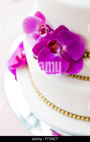 Close-up of Wedding cake decorated with fushia orchids, Canada Stock Photo
