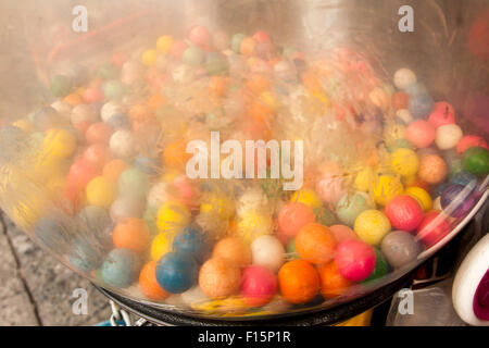 Multi-colored gumballs in a gumball machine on Mission Street, in The Mission, San Francisco, California. Stock Photo