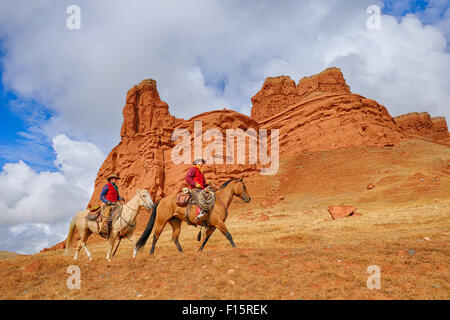 Cowboy and Cowgirl Riding Horses, Wyoming, USA Stock Photo