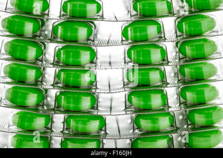 Green tablets in plastic packing as background Stock Photo