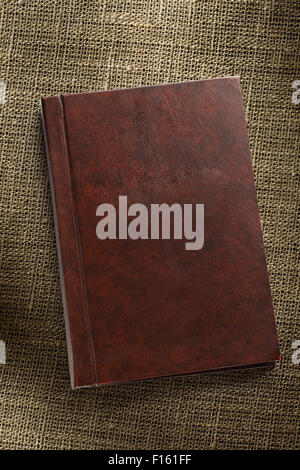 Closed brown notebook on the sack background Stock Photo