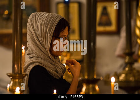 New York, United States. 27th Aug, 2015. A parishioner makes the sign of the cross at the conclusion of a prayer. On the eve of the Feast of the Dormition of the Virgin; the twelfth and final 'Great Feast' in the ecclesiastical calendar; a vigil service was held at the Synodal Cathedral for the Russian Orthodox Church Outside of Russia, officiated by Bishop Nicholas of Manhattan and visiting Bishop Gabriel of Montreal. © Albin Lohr-Jones/Pacific Press/Alamy Live News Stock Photo