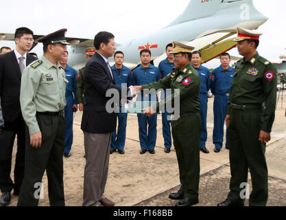 Yangon, Myanmar. 28th Aug, 2015. Chinese Ambassador to Myanmar Hong Liang (3rd L) shakes hands with Lieutenant-General Ye Aung of Myanmar's Defense Ministry after handing over document of relief supplies at the Nay Pyi Taw International Airport, Myanmar, Aug. 28, 2015. Two military aircrafts from the Chinese People's Liberation Army (PLA) arrived at Myanmar's Nay Pyi Taw International Airport Friday morning with relief supplies to flood victims of the country. © U Aung/Xinhua/Alamy Live News Stock Photo