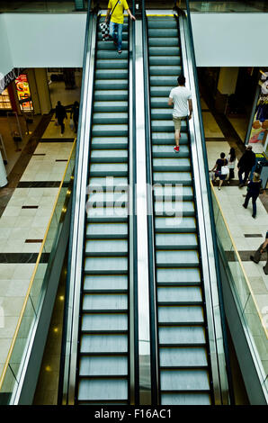 people on escalators in a shopping mall Stock Photo