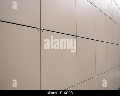 Beige wall of the large decorative tiles photographed at an angle for use as background. Selective focus Stock Photo
