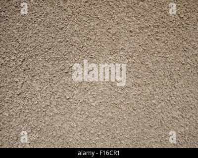 Granular surface of the cement beige. It occupies the entire space of the image. It can be used for background or wallpaper Stock Photo