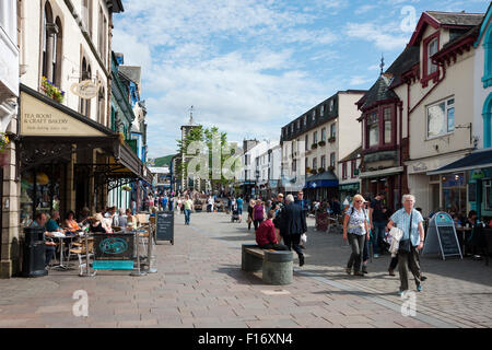 People tourists visitors walking around the town centre in summer Keswick Cumbria England UK United Kingdom GB Great Britain Stock Photo