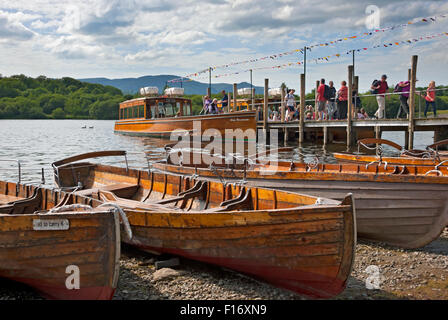 People tourists visitors on boat boats landing at the lakeside in summer Derwentwater Keswick Cumbria England UK United Kingdom GB Great Britain Stock Photo