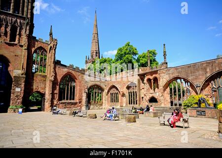 View inside the old Cathedral ruin with the Holy Trinity Church spire to the rear, Coventry, West Midlands, England, UK, Europe. Stock Photo