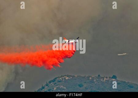 An super DC-10 air tanker drops fire retardant on the Rough Fire burning in the Sierra National Forest August 26, 2015 near Hume Lake, California. The fire caused by lightning has consumed an estimated 55,959 acres. Stock Photo