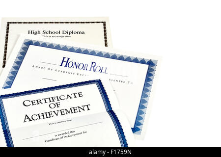 Education documents including high school diploma, honor roll recognition, and certificate of achievement isolated on white Stock Photo