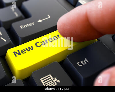 Computer User Presses Yellow Button New Career on Black Keyboard. Closeup View. Blurred Background. Stock Photo