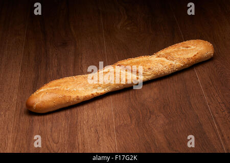 French baguette bread on dark wooden table background Stock Photo