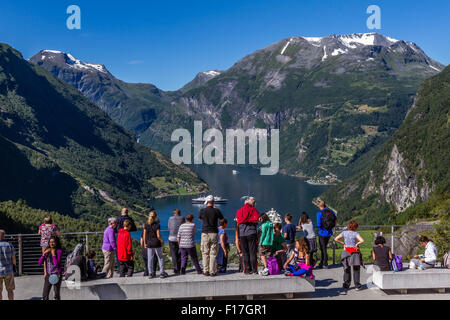 Tourists at viewpoint overlooking Geiranger, Norway Stock Photo