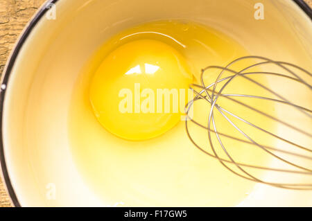 Eggs in a bowl and beater steel top view Stock Photo