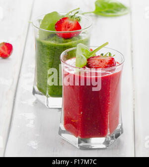 Healthy Spinach and strawberry smoothies in two glasses. Stock Photo