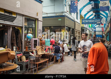 Brixton Village market, London, UK. People enjoy food and drink in Brixton Village, Brixton's iconic covered market. Stock Photo