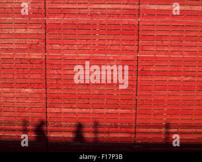 The silhouette of people against a bright red background Stock Photo