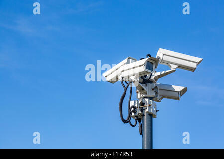 Four CCTV surveillance cameras on a pole Stock Photo