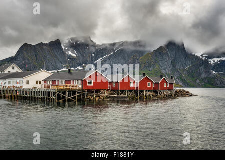 Red fishing cabins called Rorbu  in town of Hamnoy on Lofoten islands, Norway Stock Photo