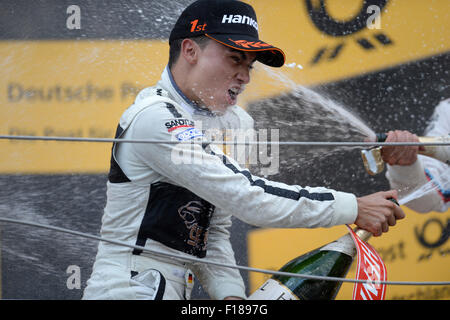 Sheludkovo, Russia. 29th Aug, 2015. First-placed German driver Pascal Wehrlein of Gooix/Original-Teile Mercedes-AMG Team celebrates with champagne during awarding ceremony for DTM race 1 at Moscow Raceway in Sheludkovo, Russia, Aug. 29, 2015. © Pavel Bednyakov/Xinhua/Alamy Live News Stock Photo