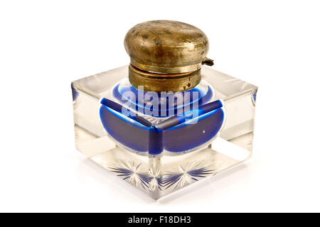 Antique glass inkwell with blue ink isolated on white Stock Photo