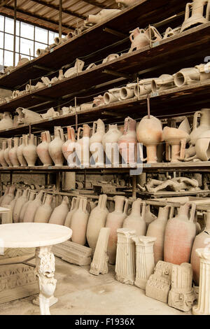 Pots and other artifacts from Pompeii in storage and on display on shelving Stock Photo
