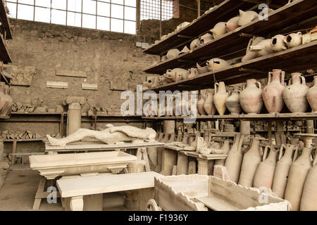Pots and other artifacts from Pompeii in storage and on display on shelving Stock Photo