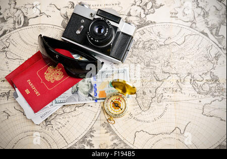 Main travel items for journey over medieval world map Stock Photo