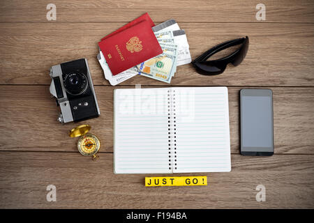 Retro style travel stuff on wooden table Stock Photo