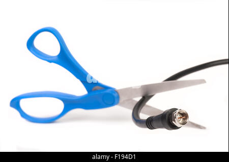Scissors cutting through a coaxial RG6 cable - cut the cable tv concept isolated on white background Stock Photo