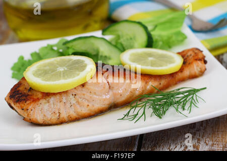 Grilled salmon fillet with lemon and fresh dill Stock Photo