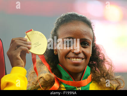Beijing, China. 30th Aug, 2015. Ethiopia's Mare Dibaba poses with her gold medal on the podium after winning the women's Marathon race during the Beijing 2015 IAAF World Championships at the National Stadium, also known as Bird's Nest, in Beijing, China, 30 August 2015. Photo: Michael Kappeler/dpa/Alamy Live News Stock Photo
