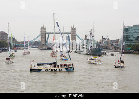 London, UK. 30th August, 2015. Clipper yachts parade on the River Thames as they leave London under a raised Tower Bridge for the start of the Round the World Clipper Race 2015. Credit:  Shipping pics/Alamy Live News Stock Photo