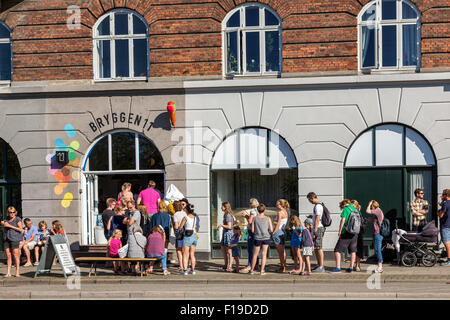 People queuing in front of ice cream shop, Islands Brygge, Copenhagen, Denmark Stock Photo
