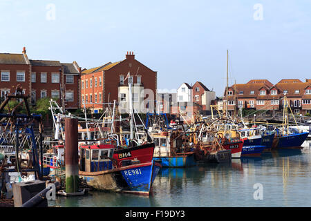Crowded fishing port in old Portsmouth. Row of boats tied up in the Camber Docks. Stock Photo