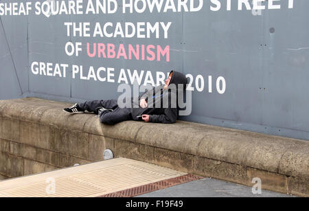 Man asleep outside Sheffield railway station in Sheaf Square Stock Photo