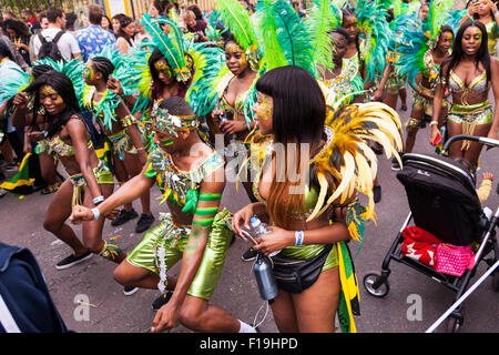 Caribbean dancers in their costumes take part in the Notting Hill Carnival, Europe's largest street festival Stock Photo