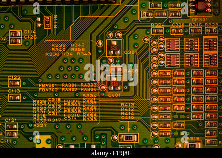 Circuit board closeup showing conductive traces, and component labels Stock Photo