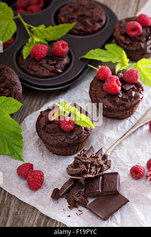 Chocolate raspberry yogurt muffins with pieces of chocolate and muffin tin Stock Photo