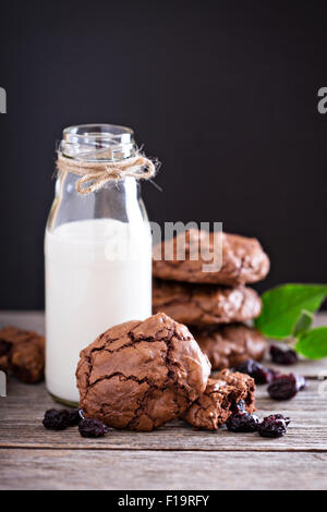 Chocolate cherry cookies and a bottle of milk Stock Photo