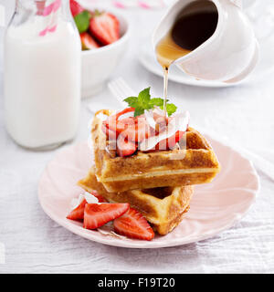 Ricotta waffles served with fresh strawberries and maple syrup Stock Photo