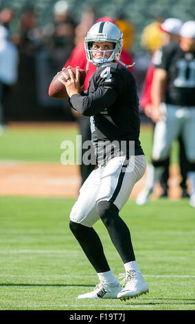 Oakland, CA. 30th Aug, 2015. Oakland Raiders quarterback Derek Carr (4)warms up prior to the NFL football game between the Oakland Raiders and the Arizona Cardinals at the O.co Coliseum in Oakland, CA. The Cardinals defeated the Raiders 30-23. Damon Tarver/Cal Sport Media/Alamy Live News Stock Photo