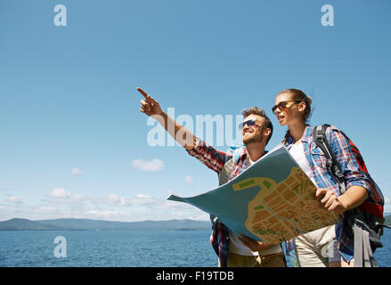 Young couple with map choosing route for further trip Stock Photo